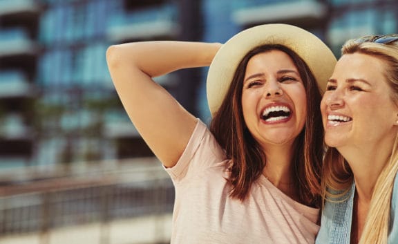 Two women looking up and laughing