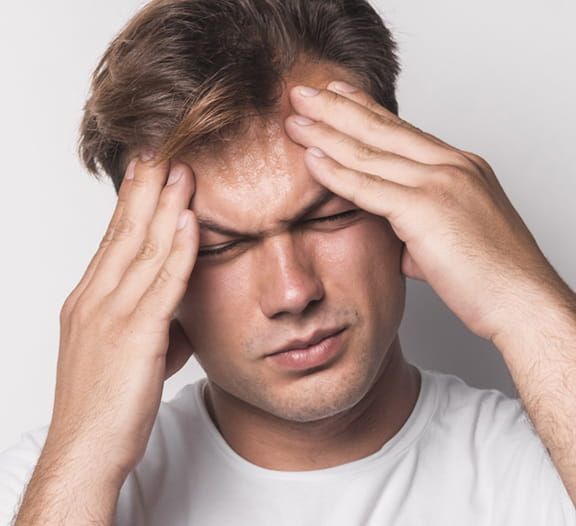 Man holding face in pain