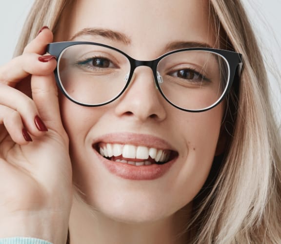 Young woman with glasses smiling