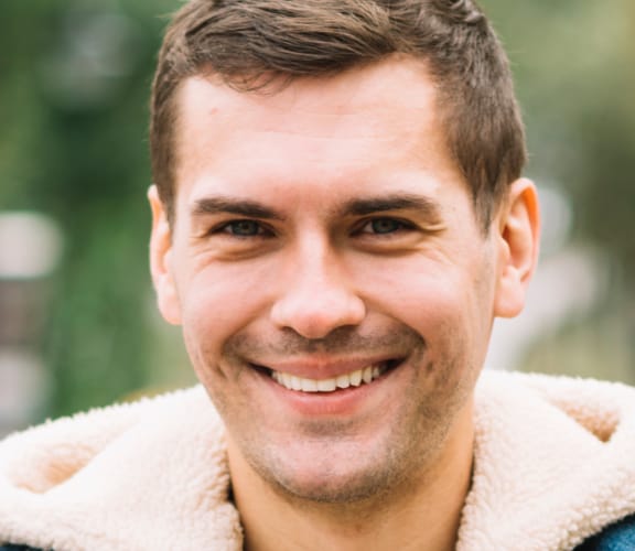 Man standing in the park and smiling